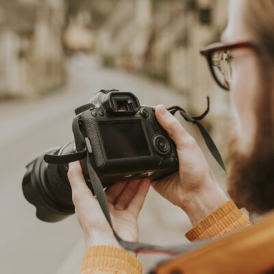 photographer man viewing his photos camera